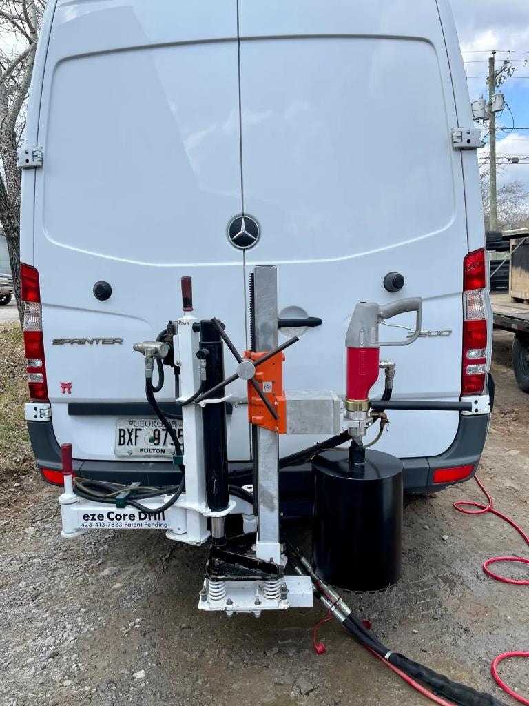 Eze Core Drill hitch-mounted on white Mercedes Sprinter van