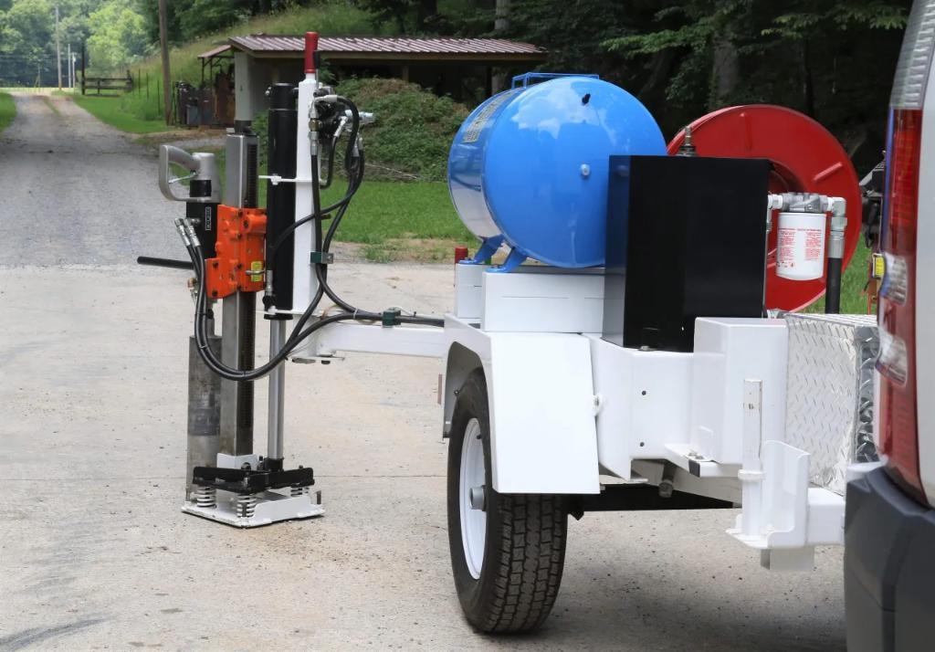 Core drill trailer with blue water tank on driveway