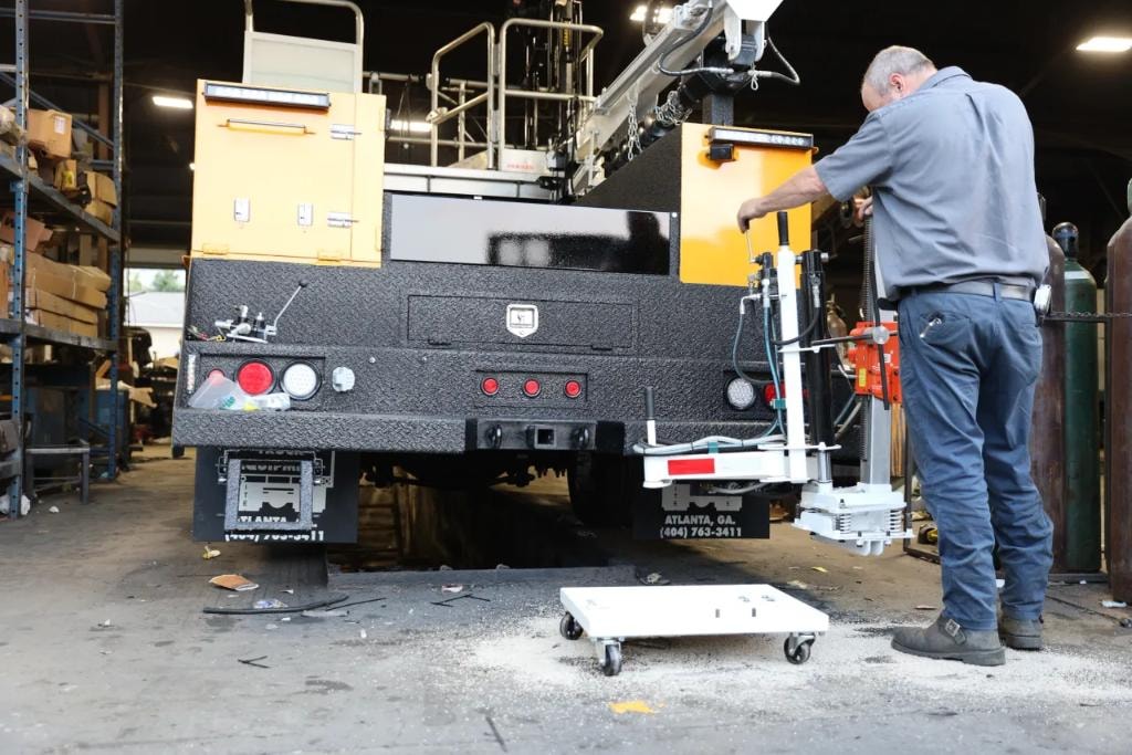 Close-up of drill rig mounted on yellow service truck bed