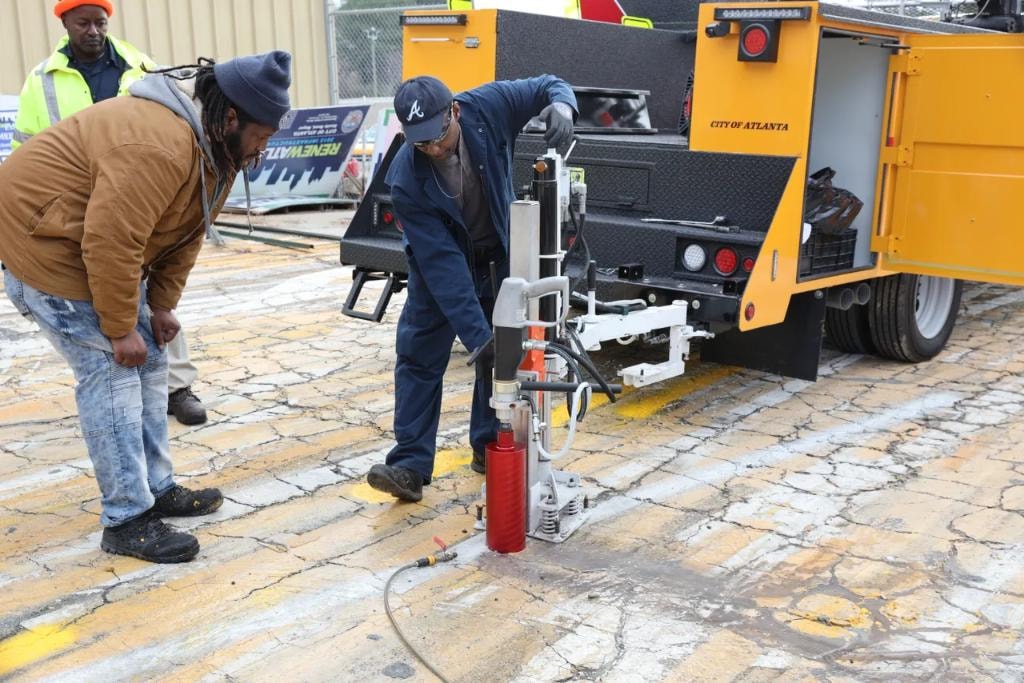City of Atlanta workers operating core drill on pavement