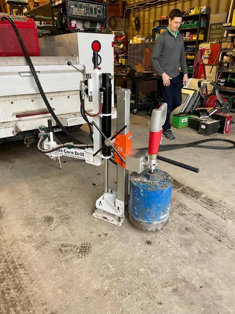 Core drill in workshop with large blue core bit