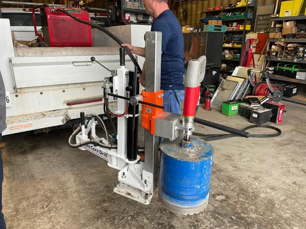 Operator running core drill in workshop
